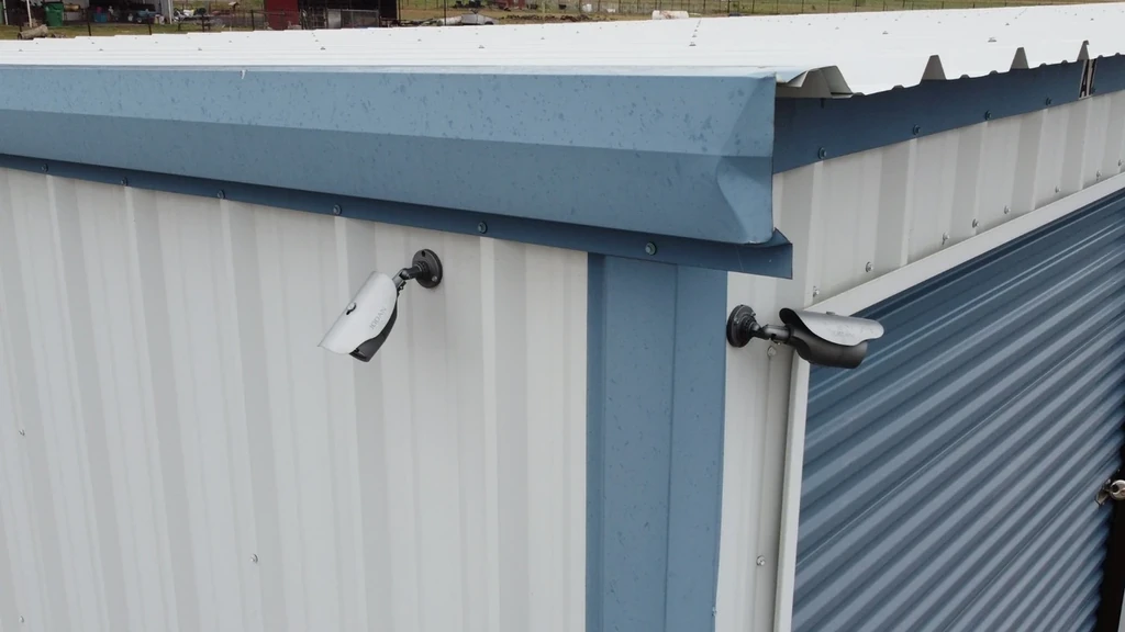 Close up of 2 security cameras on drive-up storage units
