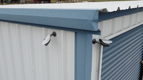 Close up of 2 security cameras on drive-up storage units