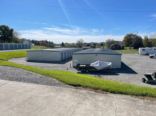 Drive-up storage units with metal doors and wide access lanes with vehicle storage at Volunteer Storage Seymour.