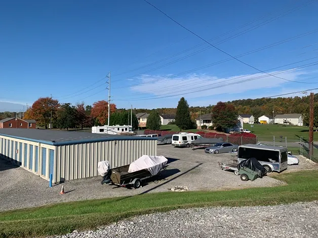 Clean gravel driveways between rows of storage units and vehicle storage at Volunteer Storage Seymour.