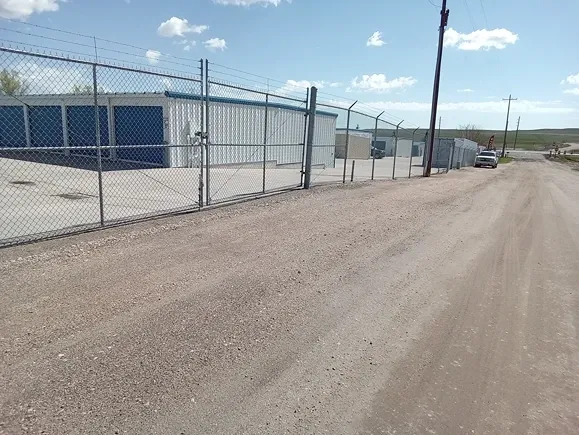 Exterior of Speedway Storage with multiple unit rows and fencing.