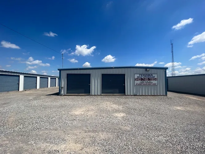 Exterior of outdoor storage units with permanent signage at Texoma Self Storage facility.