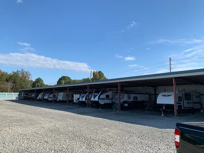 Wide view of lot layout and covered parking units at Volunteer Storage Vonore.