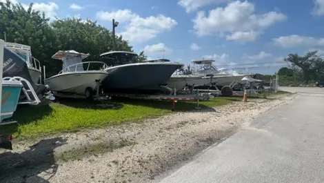 Outdoor vehicle storage with boats at Big Pine Storage.