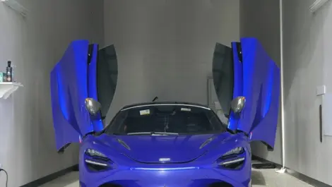 View of blue car in storage unit.