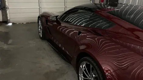 View of a car parked in a storage unit at Volunteer Storage Lenoir City facility.