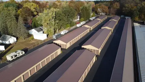 Long row of drive-up storage units with gravel lanes at Lambertville Mini Storage Secor.