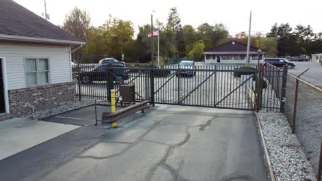Gate entrance with keypad and fencing at Lambertville Mini Storage Secor.