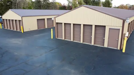 Clean, gravel-covered vehicle storage area at Lambertville Mini Storage Secor.
