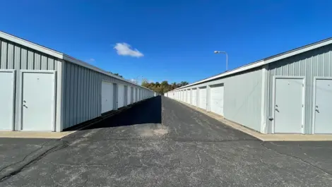 Fenced vehicle parking area with adjacent storage buildings at Osprey Storage Shaver.