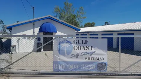 Open lot with gravel and paved sections at Gulf Coast Self Storage Sherman Ave.