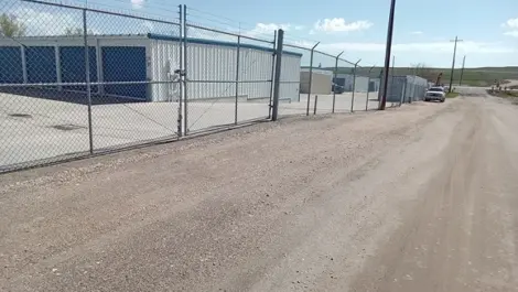 Exterior View of Speedway Storage with multiple unit rows and fencing.