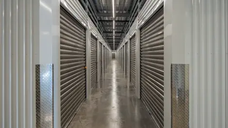 Storage unit hallway with white doors and polished floors at Storage Lounge.
