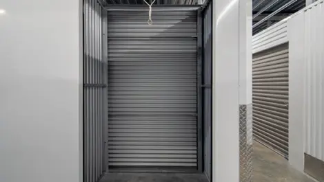 Long, straight hallway lined with storage units at Storage Lounge.