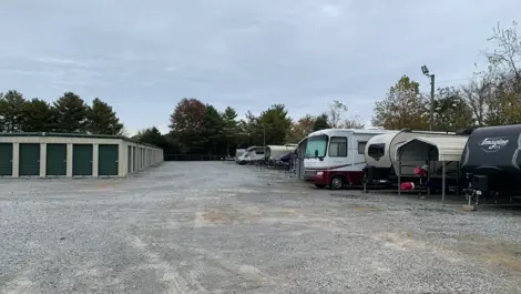Long rows of drive-up storage units with gravel access at Volunteer Storage Tellico Village.