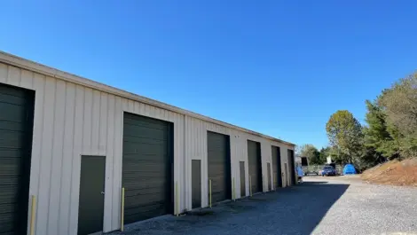 Drive-up storage unit doors and wide access drive at Volunteer Storage Tellico Village.
