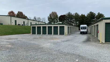 Storage units with gravel surface and open sky backdrop at Volunteer Storage Tellico Village.