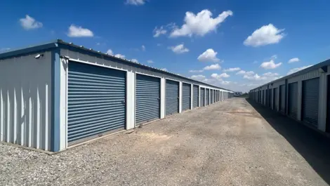 Drive-up storage units with roll-up doors and wide access lanes at Texoma Self Storage.