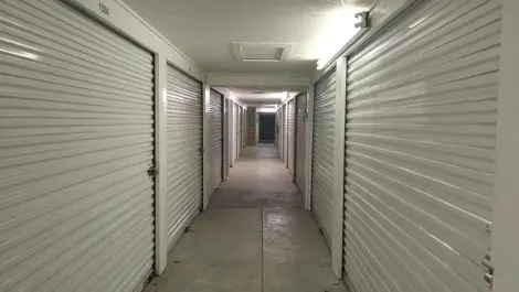 Indoor hallway with bright lighting and unit doors at Town and Country Self Storage.