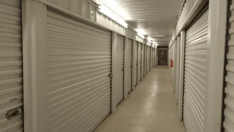 Interior corridor of storage units with polished floors at Town and Country Self Storage.
