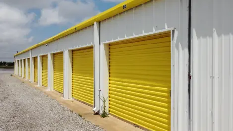Exterior units with drive-up access and metal roll-up doors at Vernon Self Storage.