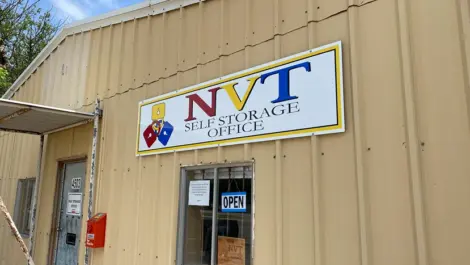 Long rows of drive-up storage units with gravel access at Vernon Self Storage.