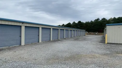 Wide gravel lot with drive-up access to units at Volunteer Storage Vonore.