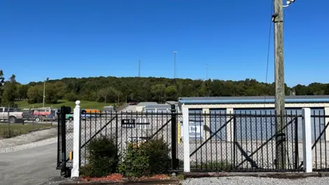 Exterior of drive-up storage units with metal roll-up doors at Volunteer Storage Vonore.