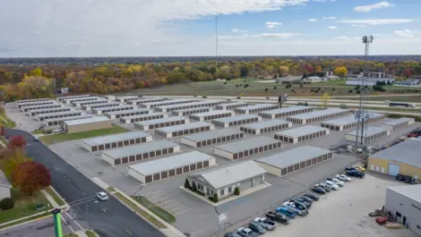 Storage unit building with roll-up doors and gravel lot at Osprey Storage Howard.