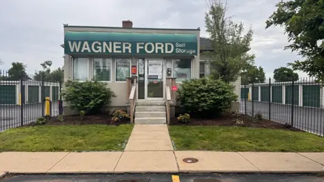 Wagner Ford Self Storage office with fenced in units in the background.