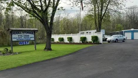 Hugill Storage West entrance with sign and storage units in the background.