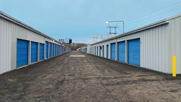 French Creek Self Storage outside units with units on both sides of a wide aisle.