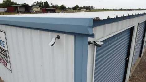 Exterior of outdoor storage units at Texoma Self Storage facility showing security camera.