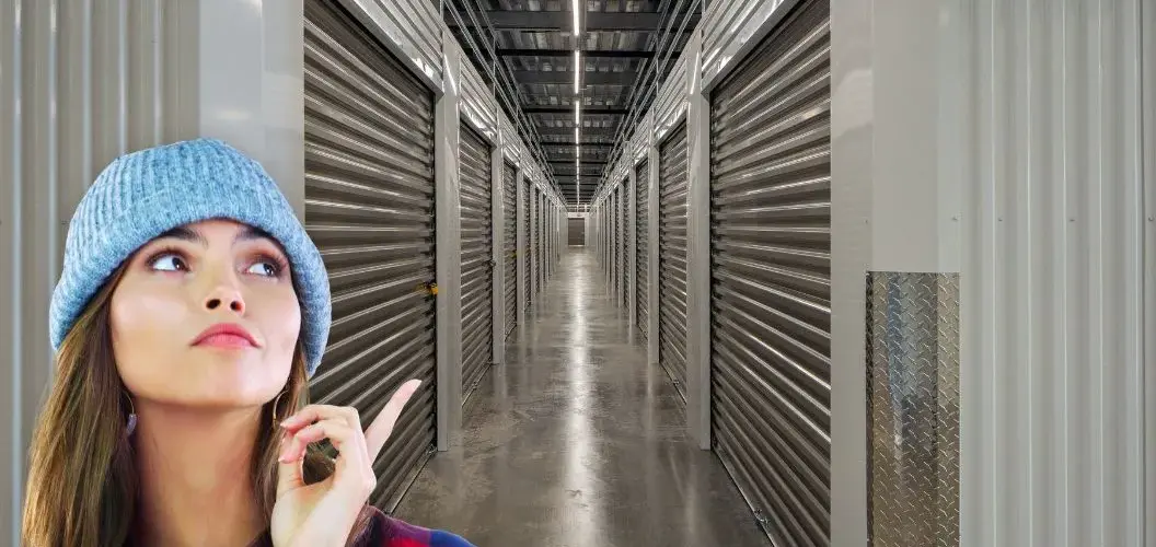 Woman contemplating storage with climate controlled units behind her.
